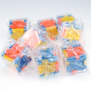Detailed view of mini 3D maze cubes in individual plastic bags for bulk wholesale set