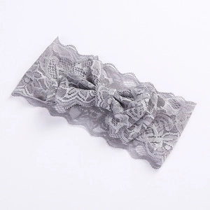 Detailed view of grey lace bow headband featuring intricate floral镂空 patterns