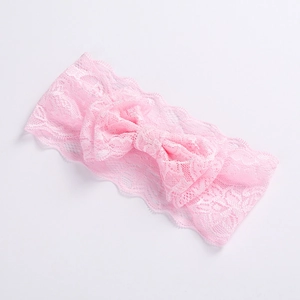 Close-up of pink lace baby headband showing the delicate double-layer bow texture