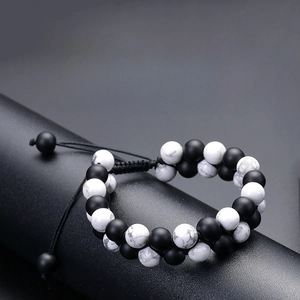 Detail of adjustable double-layer distance bracelets with matte black and white marble beads