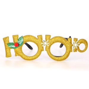 Close-up of gold HO HO HO glitter Christmas glasses with holly and snowflake details