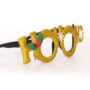 Detail of gold glitter HO HO HO Christmas glasses with holly leaves and snowflake accents