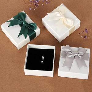 Elegant white square jewelry gift boxes with satin bows for rings and necklaces