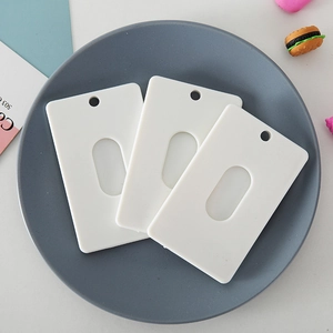 Three white ABS plastic card holders with hanging holes on a grey display plate