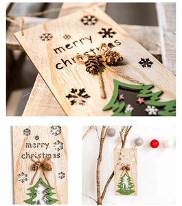 Close-up of wooden Merry Christmas door sign with pine cones and laser-cut deer scene