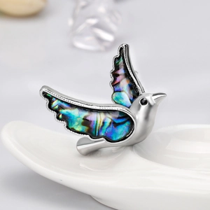 Exquisite bird brooch with colorful abalone shell wings and silver metal finish