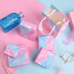 Detailed top view of pink and blue marble pattern jewelry gift boxes and matching gift bags