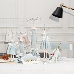 Detailed close-up of light blue fabric jewelry display stands in various elegant shapes