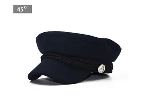 Detail view of navy blue wool baker boy hat with black braided rope and silver buttons