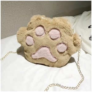 Detail of cute plush cat paw crossbody bag with pink pads and gold metal chain strap