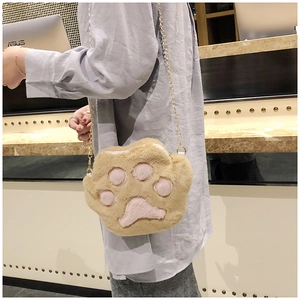 Detail of cute plush cat paw crossbody bag with soft pink pads and gold chain strap