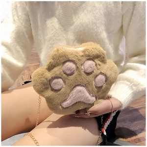 Detailed view of a plush cat paw crossbody bag with golden chain and soft faux fur texture