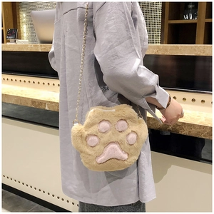Cute khaki plush cat paw crossbody bag with pink pads and gold chain strap on model