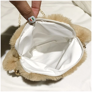 Detail of plush cat paw bag interior with white lining and secure zipper closure