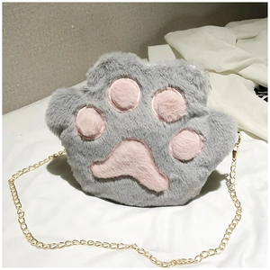 Close-up of the plush cat paw crossbody bag with soft pink pads and gold chain