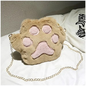 Detail of plush cat paw crossbody bag with golden chain strap and soft brown texture
