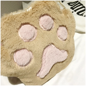 Close-up of soft plush cat paw bag with pink paw pads and golden metal chain strap