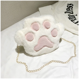 Detail of soft white plush cat paw bag with pink paw pads and gold chain strap