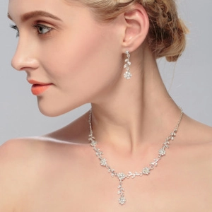 Close-up of model wearing silver pearl jewelry set with floral zircon pendant and earrings