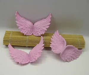 Detailed view of pink angel wing accessories with feather texture for DIY craft decoration