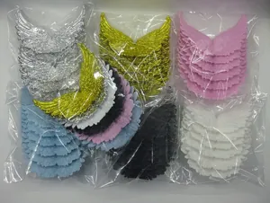 Detail of colorful embroidered angel wing patches in bulk packaging for cake decoration