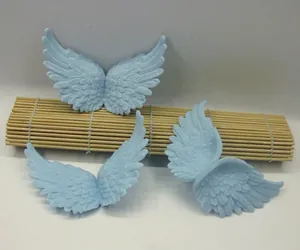 Detailed view of light blue angel wing plastic accessories with feather texture for DIY