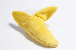 Detail of banana plush toy with soft texture and peeled fruit design for small dogs