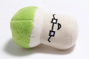 Detailed side view of green and white plush dog toy featuring soft embroidered textures