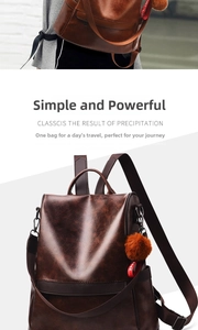 Detail of dark brown leather backpack with fuzzy pom-pom and red ribbon decorative charm