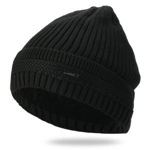 Detail of black winter knit hat featuring warm fleece lining and a classic metal tag