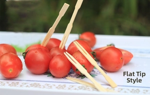 Flat-head bamboo fruit picks inserted in cherry tomatoes for party snacks and desserts