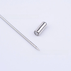 Macro detail of silver metal lapel pin needle and matching cylindrical stopper cap