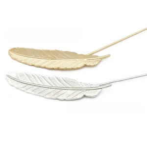Detailed view of alloy leaf feather pins in gold and silver finishes for suits