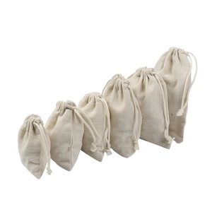 Detailed set of 6 beige drawstring cotton linen pouches in varying sizes for packaging