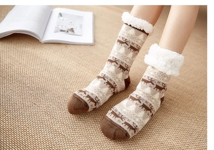 Detailed close-up of thick fleece lining and reindeer pattern on winter slipper socks