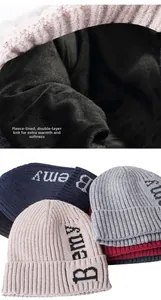 Detail view of the thick fleece lining and folded brim on the knitted letter beanie
