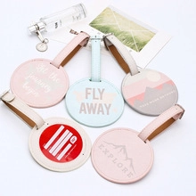 Detailed view of colorful PU leather luggage tags with travel patterns and buckle straps