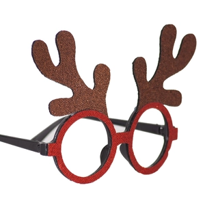 Detail of red glitter Christmas reindeer antlers glasses frame for festive party decor