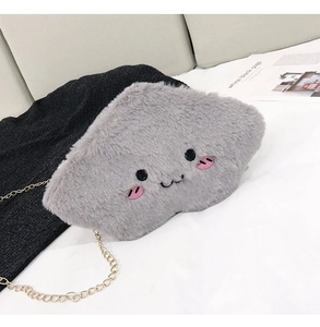 Macro detail of a grey plush cloud-shaped bag with embroidery and gold chain strap