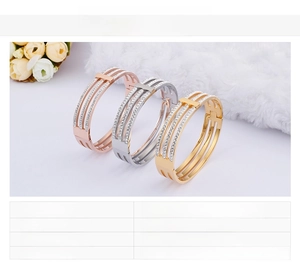 Detailed close-up of triple-layered titanium steel bangles with sparkling crystals