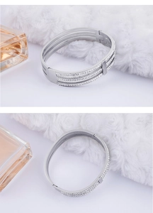 Detailed close-up of triple-layer silver-tone bangle with sparkling crystal inlay