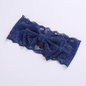 Close-up of blue lace headband for girls with elegant double-layered bow detail