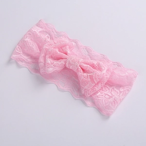 Detailed view of pink double-layer lace baby headband with large decorative bow detail