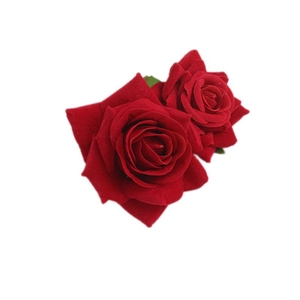 Close-up of red velvet artificial rose hair clip with detailed flower petals and texture