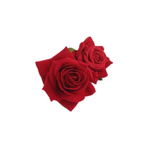 Detail view of double red velvet faux rose hair clips with realistic layered petals
