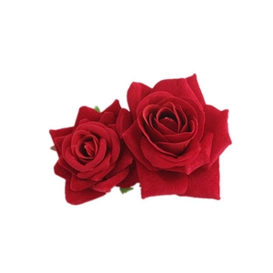 Detailed view of two red velvet artificial roses hair clip accessory with realistic petals
