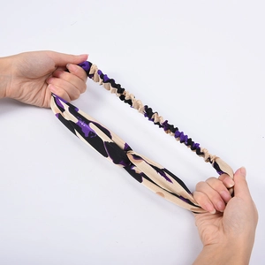 Elastic leopard print headband in beige and purple shown being stretched for flexibility