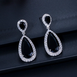 Macro detail of tear-drop earrings with black pear-cut stone and pavé zircon border