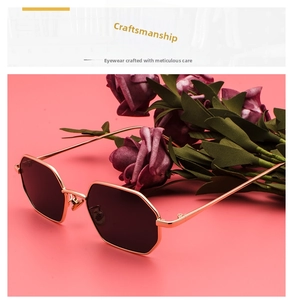 Detail macro of vintage octagonal metal sunglasses with golden frame and dark lenses