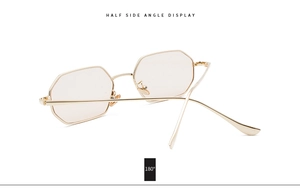 Detail of octagonal metal sunglasses with golden frame and 180 degree flexible hinge